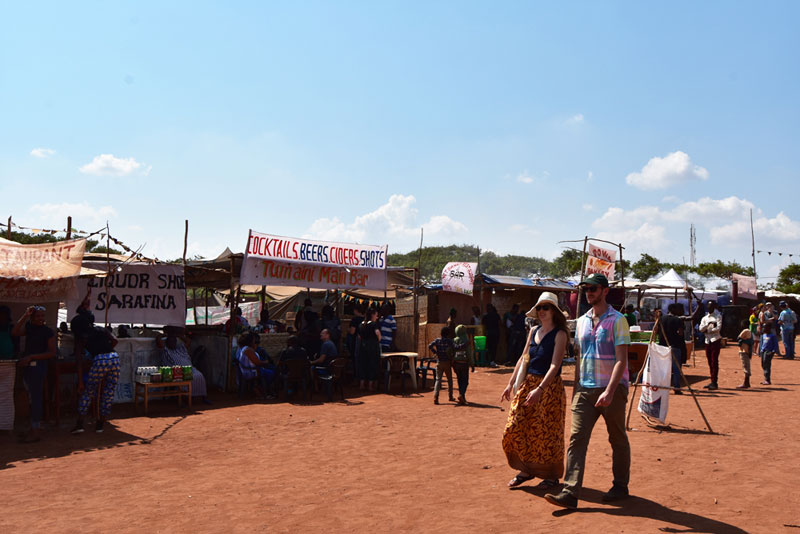 A row of watering holes and food stalls at Tumaini