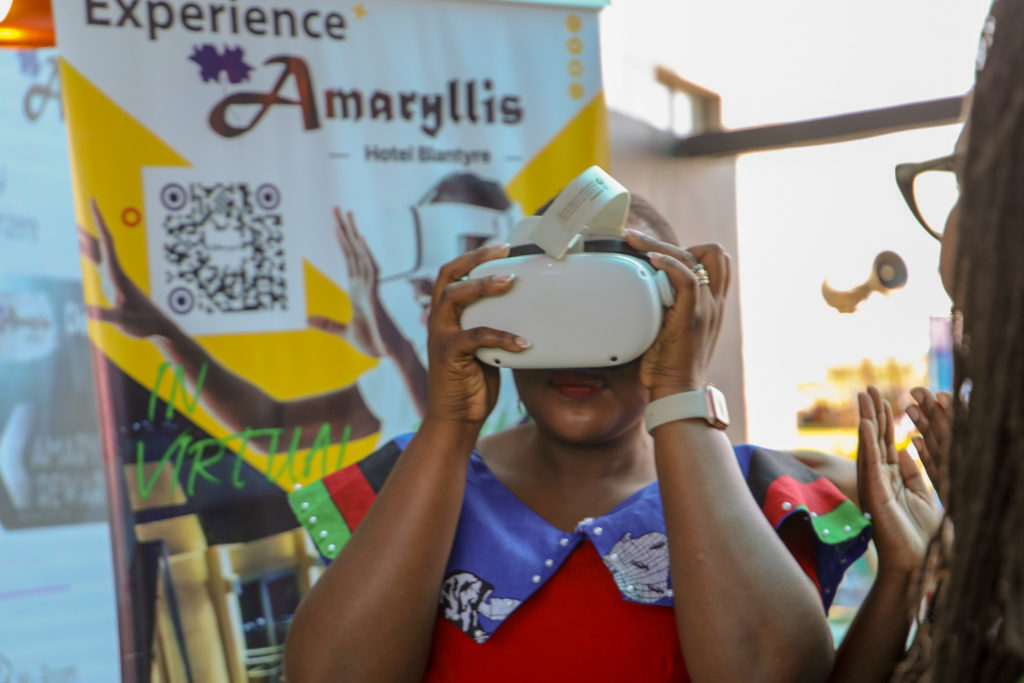 Tourism minister using a VR headset at Amaryllis Hotel stand at the Malawi Takulandirani Tourism Expo